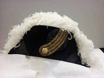 Black fur cocked hat with white ostrich feather border.