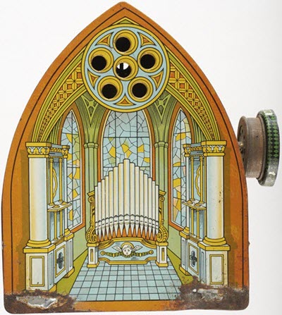 A painted tin-plated musical box with abrasion damage.