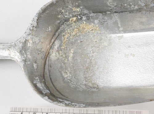 Corroded aluminum scoop.