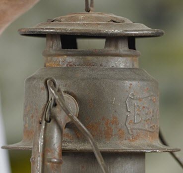 Detail of a lantern, showing patina and rusting.
