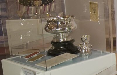 Exhibit display cases protecting silver objects.