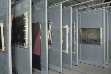 Paintings hung in a sliding screen storage system.