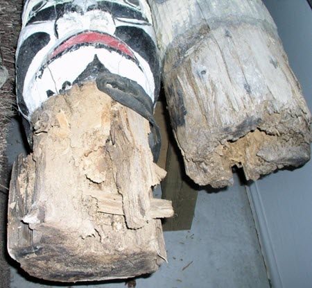 Wood rot at the bases of the totem poles.