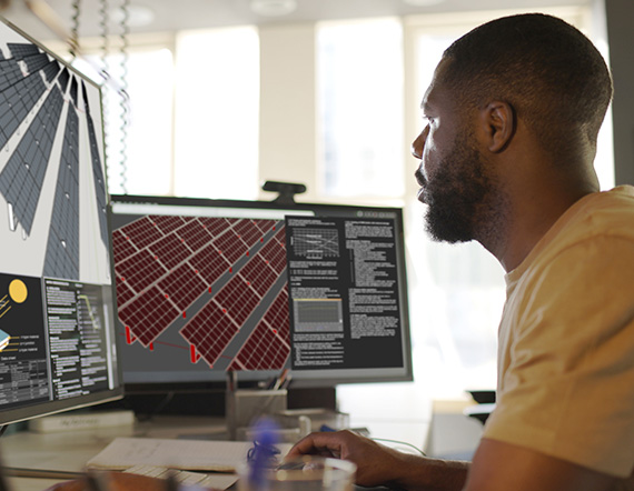An engineer uses a computer to design solar panels.