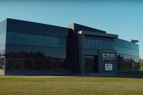 Photo of ACET’s windowed headquarters on a sunny day.