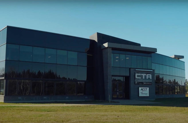 Photo of the ACET’s windowed headquarters on a sunny day.