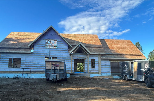 Maison en construction faite avec les blocs OSBLOCK, montrant la structure et les murs extérieurs avant la finition.