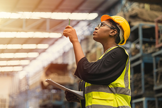 Professional women worker working checking inventory production stock control in factory.