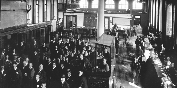 Marketers in the Winnipeg Commodity Exchange Building in Manitoba viewing the most recent grain statistics from the published Canadian grain statistics reports.