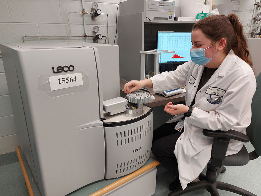 Lab technician operating CNA equipment.