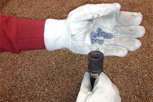 Fumigant pellets are placed into bulk stored grain using a hollow probe