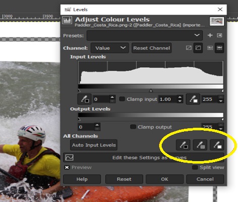 Screenshot of GIMP showing the “Adjust Colour Levels” dialogue box positioned in front of an image of a kayaker.