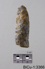 Colour photo of a sharpened stone tool (possibly a spear head), 2 cm scale at base and BiCu-1:3366