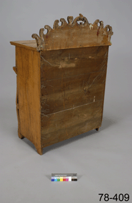 Colour photo of a wooden piece of furniture, viewed from behind, with catalogue number 78-409 on a grey background.