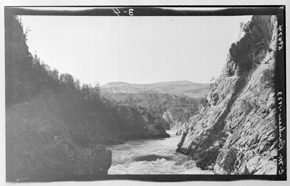 Black and white photograph of mountainous river landscape, showing reversed colours and reframed image