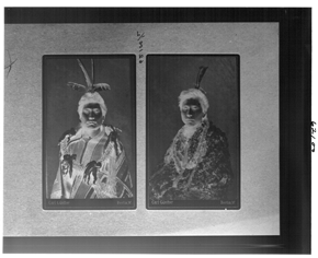 Double portrait of two seated men wearing traditional First-Nations garb, negative (original) image.