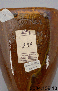 Colour photo of ceramic object with brown glaze and the trademark in view with 2004.159.13