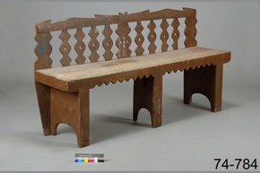 Colour photo of wooden bench with three leg sections and a decorative back-rest, with catalogue number 74-784 on a grey background.