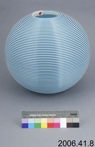 Colour photo of a blue and white circular sphere with catalogue number 2006.41.8 on a grey background.
