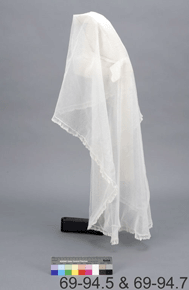 Colour image of translucent - white veil on pedestal, rear view, with catalogue number 69-94.5 & 69-94.7 on a grey background.