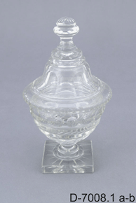 Colour image of intricate decorated glass or crystal container with matching lid on top and D-7008.1 a-b