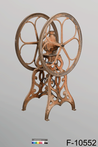 Colour photo of copper coloured metallic device with large wheels, situated on a wooden platform, with catalogue number F-10552 on a grey background.