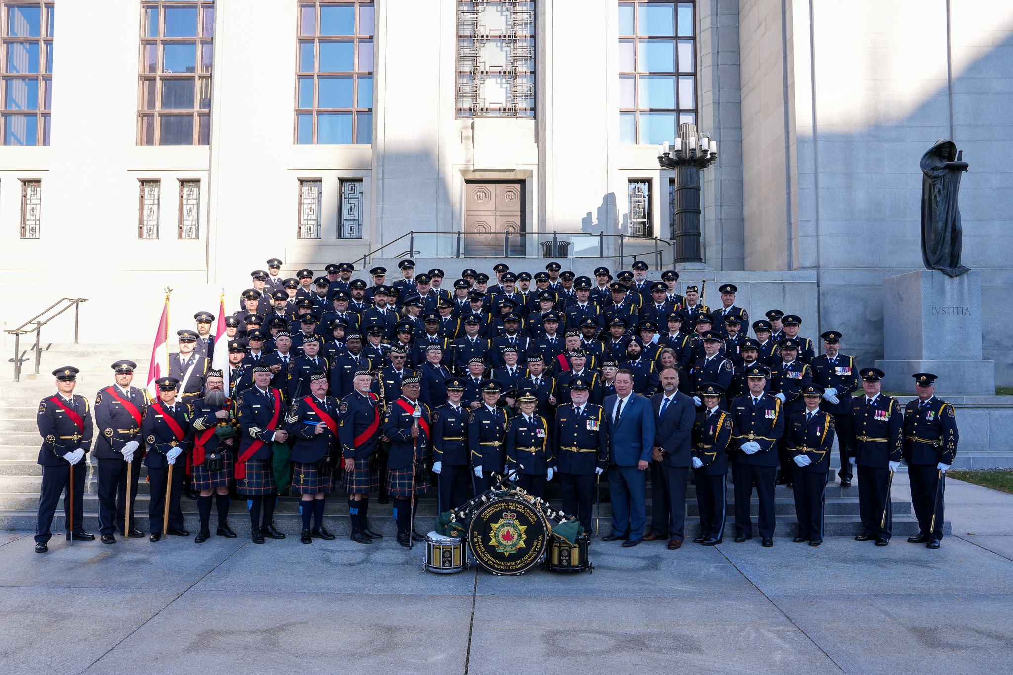 a group photo with people in uniform outside