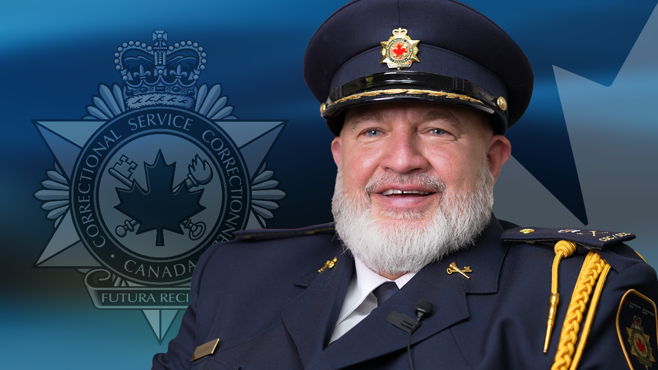 A photo of Henry wearing his CSC uniform with a CSC badge and Canadian maple leaf in the background.
