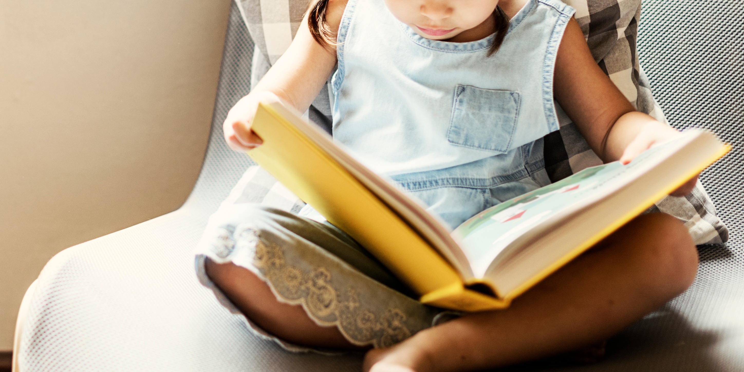 Girl seated reading book