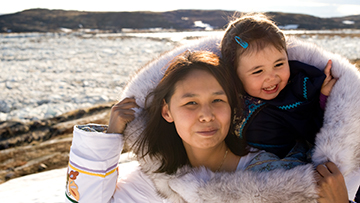 Inuit mother and daughter in traditional clothing.