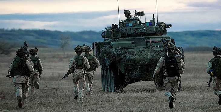 Members of 2nd Battalion, The Royal Canadian Regiment regroup and prepare to mount up in a Light Armoured Vehicle (LAV 6) during a simulated assault at Saville Farm in the Wainwright training area, during Exercise MAPLE RESOLVE on May 11, 2022.