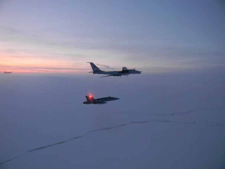 North American Aerospace Defense Command F-22s, CF-18s (seen in the distance) supported by KC 135 Stratotanker and E-3 Sentry Airborne Warning and Control System aircraft, intercepted two Russian Tu-142 maritime reconnaissance aircraft entering the Alaskan Air Defense Identification Zone on 9 March 2020