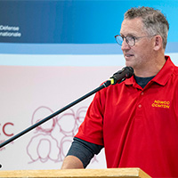 Acting Champion MGen Girouard giving a speech at the awards ceremony after the canoe race.