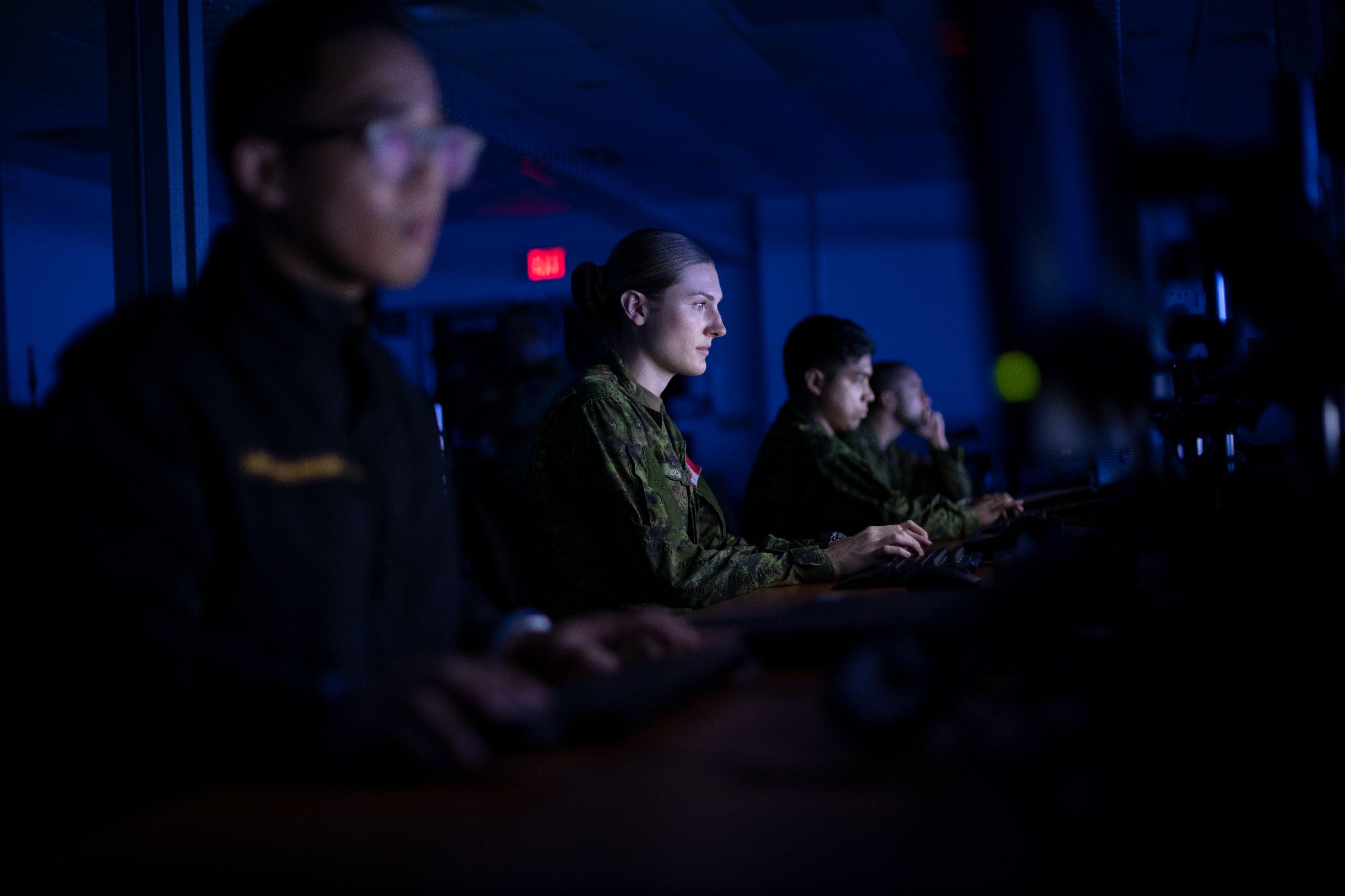 Military personelle working on computers.