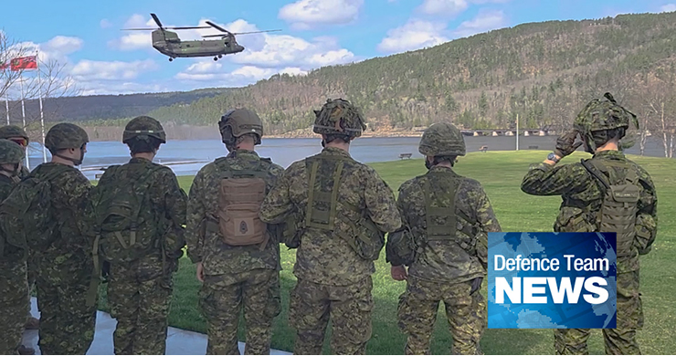 soilders stand next to lake