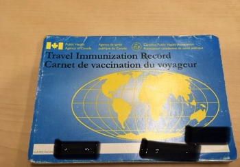 A Travel Immunization Record booklet that includes name, Service number, and vaccination details.