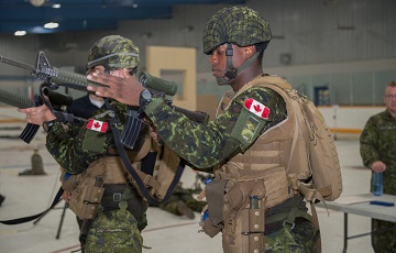 Two soldiers carrying guns side by side