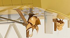 Two propellers are mounted on the bottom of a yellow boat.