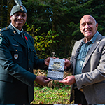 2Lt Downey presents Mr Charles Thevenin with a copy of a book about No.2 Construction Battalion in Supt on November 10, 2021. Mr Thevenin has authored a book about the Canadian troops in the area during the First World War, including No.2 Construction Battalion.  Photo by Cpl Brad Upshall.