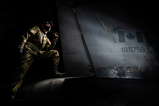 Man standing on tail wing
