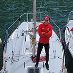 The 2023 RMC Varsity Club Sailing Team’s Team Captain NCdt Jamie De Lachevrotière-Martin (center) onboard the keelboat class J/24 sailboat named Charly on which the team competed against about 14 other sailboats from different countries, including Italy on the left and Chile on the right.