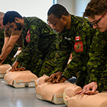First aid courses, a crucial part of recruit training. In this session, candidates practice cardiopulmonary resuscitation (CPR) techniques on medical mannequins.