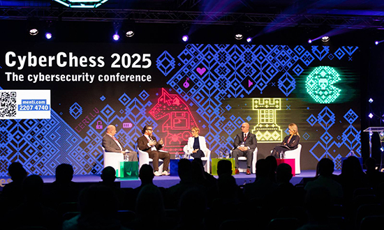 Five panelists, including Brigadier-General Scott MacGregor, sit on stage under a large CyberChess 2025 banner during a cybersecurity conference in Riga, Latvia.