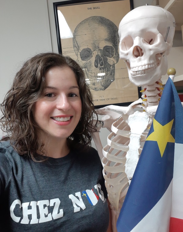 Dr. Sarah Lockyer in front of a human skeleton model