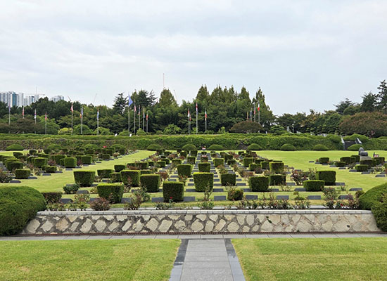 Wide shot of a neatly landscaped cemetery.