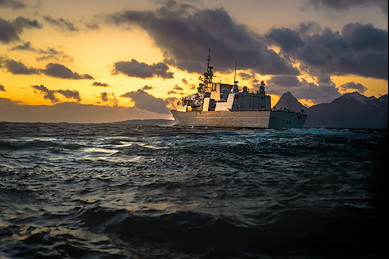 The Formidable Ship: A Canadian military vessel moves through the water under overcast skies, emphasizing its power and readiness.