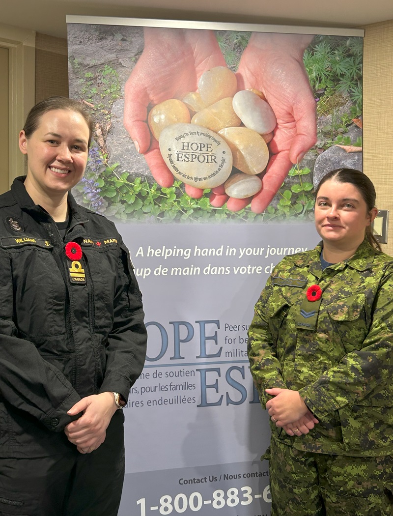 Lieutenant (Navy) Courtney Williams is smiling on the left and Corporal Nicole Lamothe is smiling on the right with the HOPE banner in the middle.