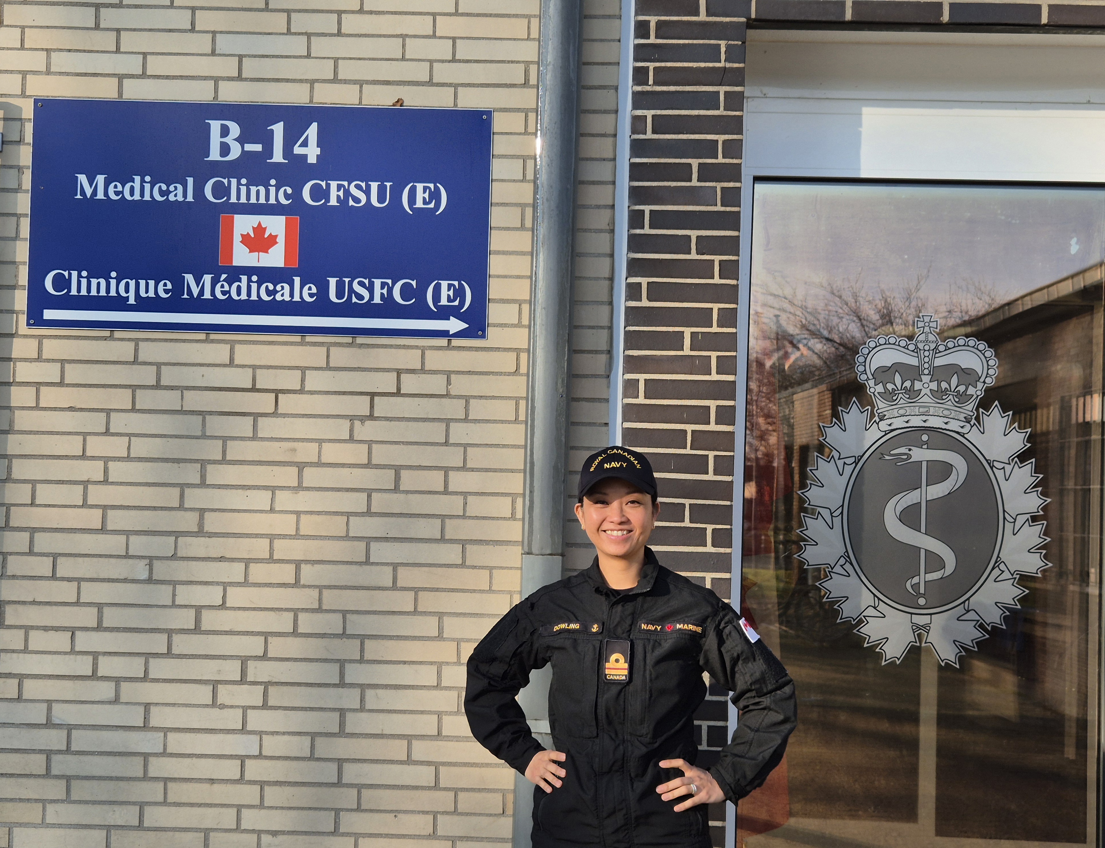 A uniformed service member stands outside the CFSU (E) Medical Clinic in Geilenkirchen, Germany