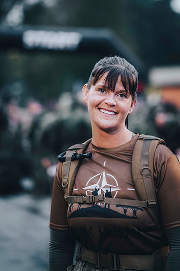 Canadian Armed Forces member wearing athletic gear and a pack during an outdoor competition event.