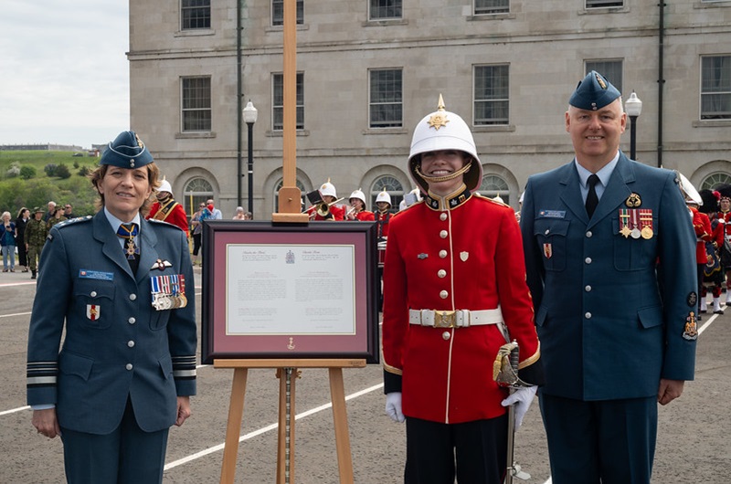 A graduate of the Royal Military College in Kingston receives the commission scroll.